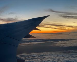 Preview wallpaper airplane, wing, clouds, flight, sky, sunset, dawn