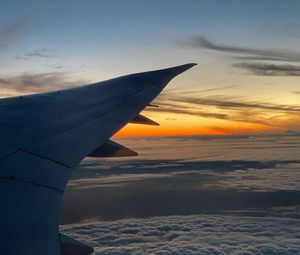 Preview wallpaper airplane, wing, clouds, flight, sky, sunset, dawn