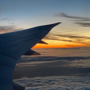Preview wallpaper airplane, wing, clouds, flight, sky, sunset, dawn