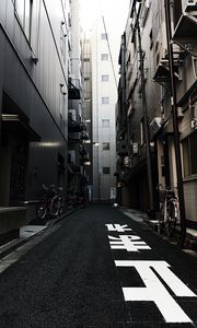 Preview wallpaper alley, buildings, asphalt, bicycles, urban