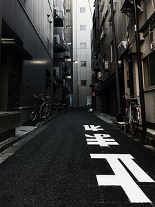 Preview wallpaper alley, buildings, asphalt, bicycles, urban