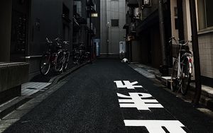 Preview wallpaper alley, buildings, asphalt, bicycles, urban