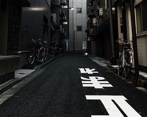 Preview wallpaper alley, buildings, asphalt, bicycles, urban