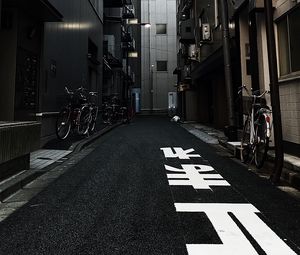 Preview wallpaper alley, buildings, asphalt, bicycles, urban