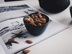 Preview wallpaper almonds, nuts, bowl, table, magazine