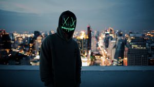 Preview wallpaper anonymous, mask, hood, hoodie, city, glow