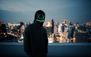 Preview wallpaper anonymous, mask, hood, hoodie, city, glow