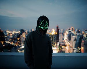 Preview wallpaper anonymous, mask, hood, hoodie, city, glow