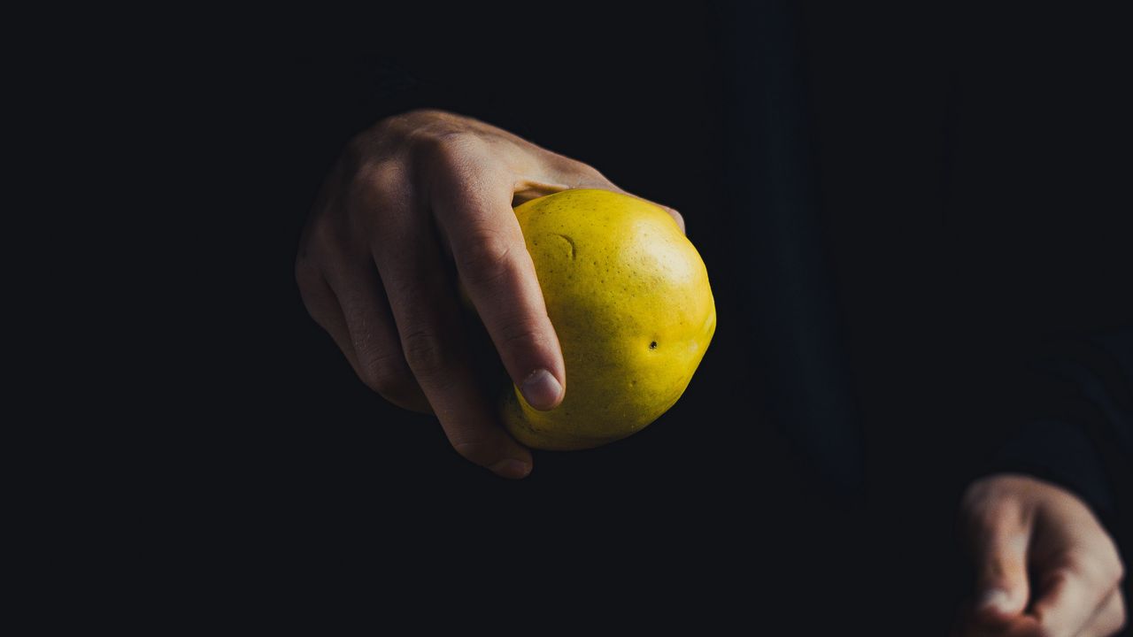 Wallpaper apple, hand, fruit, dark background