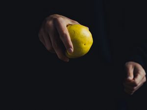 Preview wallpaper apple, hand, fruit, dark background