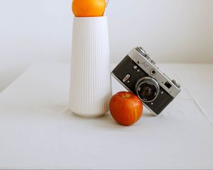 Preview wallpaper apple, orange, camera, vase, branch, decor