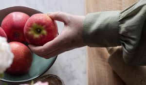 Preview wallpaper apples, fruit, hand, flowers
