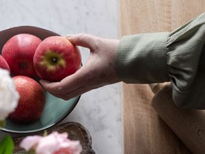 Preview wallpaper apples, fruit, hand, flowers