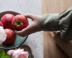 Preview wallpaper apples, fruit, hand, flowers