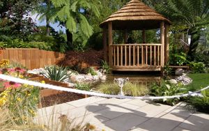 Preview wallpaper arbor, garden, tile, cup, shadow, vegetation, flowers, palm trees, lake, path