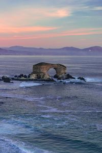 Preview wallpaper arch, rocks, sea, waves, sunset