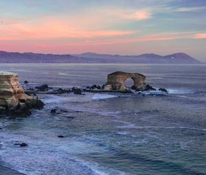 Preview wallpaper arch, rocks, sea, waves, sunset