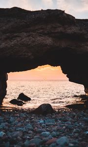 Preview wallpaper arch, stones, pebbles, sea, coast, sunset