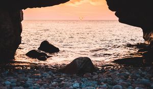 Preview wallpaper arch, stones, pebbles, sea, coast, sunset