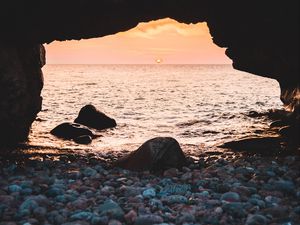 Preview wallpaper arch, stones, pebbles, sea, coast, sunset