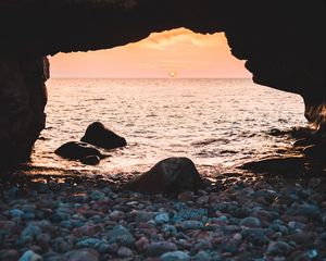 Preview wallpaper arch, stones, pebbles, sea, coast, sunset