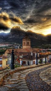 Preview wallpaper architecture, streets, mountains, old, sky, sunset, road, clouds, houses, flowers, colorful, beautiful, hdr
