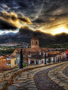Preview wallpaper architecture, streets, mountains, old, sky, sunset, road, clouds, houses, flowers, colorful, beautiful, hdr