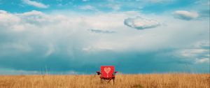 Preview wallpaper armchair, field, lonely, clouds