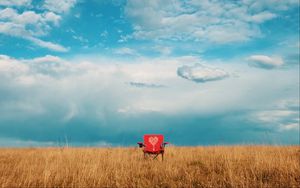 Preview wallpaper armchair, field, lonely, clouds