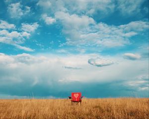 Preview wallpaper armchair, field, lonely, clouds