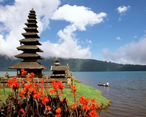 Preview wallpaper asia, island, structure, flowers, mountains, boat, people