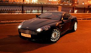 Preview wallpaper aston martin, db9, 2004, black, front view, style, cars, city, house, lights, asphalt