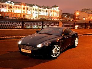 Preview wallpaper aston martin, db9, 2004, black, front view, style, cars, city, house, lights, asphalt