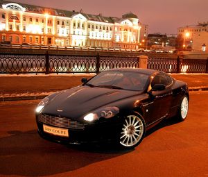 Preview wallpaper aston martin, db9, 2004, black, front view, style, cars, city, house, lights, asphalt