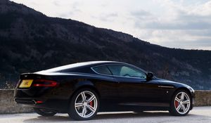 Preview wallpaper aston martin, db9, 2006, black, side view, style, cars, sports, nature, sky, mountains, trees