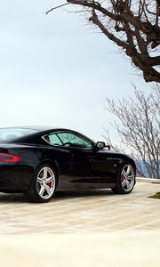 Preview wallpaper aston martin, db9, 2006, black, side view, style, sports, auto, building, tree, sky