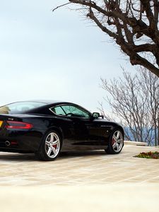 Preview wallpaper aston martin, db9, 2006, black, side view, style, sports, auto, building, tree, sky