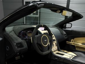 Preview wallpaper aston martin, db9, 2009, black, salon, interior, steering wheel, speedometer