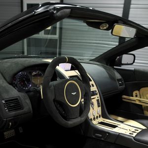 Preview wallpaper aston martin, db9, 2009, black, salon, interior, steering wheel, speedometer