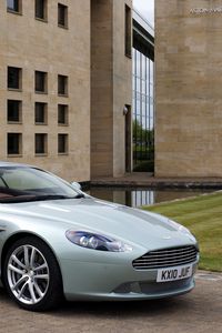 Preview wallpaper aston martin, db9, 2010, blue metallic, side view, style, sports, auto, building, grass