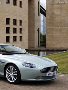 Preview wallpaper aston martin, db9, 2010, blue metallic, side view, style, sports, auto, building, grass