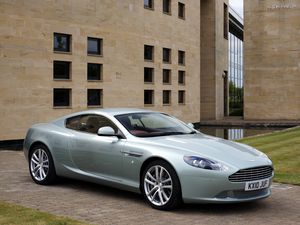 Preview wallpaper aston martin, db9, 2010, blue metallic, side view, style, sports, auto, building, grass