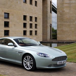 Preview wallpaper aston martin, db9, 2010, blue metallic, side view, style, sports, auto, building, grass