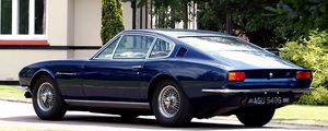 Preview wallpaper aston martin, dbs, 1967, blue, side view, style, retro, house, trees