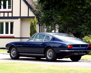 Preview wallpaper aston martin, dbs, 1967, blue, side view, style, retro, house, trees