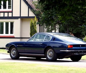 Preview wallpaper aston martin, dbs, 1967, blue, side view, style, retro, house, trees
