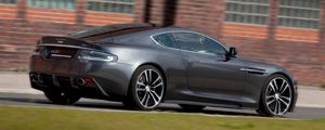 Preview wallpaper aston martin, dbs, 2010, gray, side view, cars, grass, building