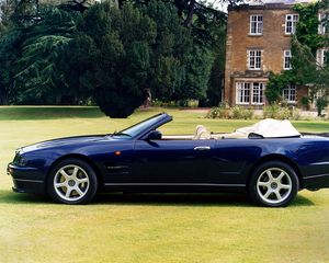 Preview wallpaper aston martin, v8, 1997, blue, side view, cabriolet, house, nature