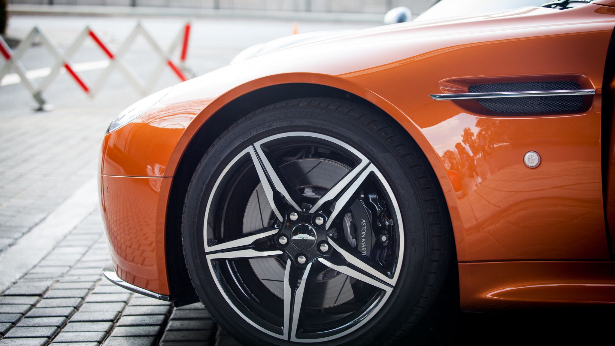 2048x1152 Wallpaper aston martin, wheel, tire, car, orange