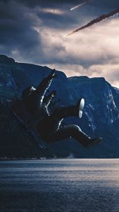 Preview wallpaper astronaut, cosmonaut, space suit, fall, photoshop, lake, mountains, dark